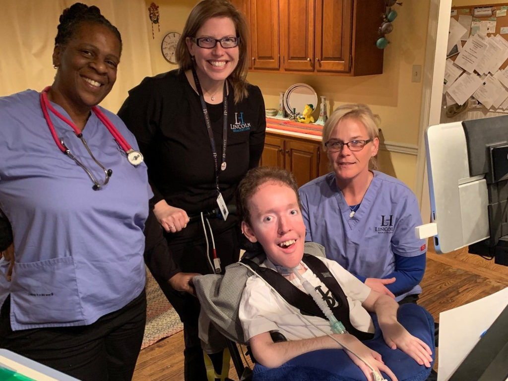 2020 03 25-provided-jack freedman dawn law-home health aides_ (1) Jack Freedman poses for a photo with licensed practical nurse Kimberly Charleston (left), clinical manager Megan Corbo (middle) and nurse Dawn Pye. Charleston has self-quarantined following a screening process instituted by her employer, Lincoln Healthcare, to send home anyone who lives with someone who may have had contact with a confirmed case of COVID-19. (Courtesy of Al Freedman)