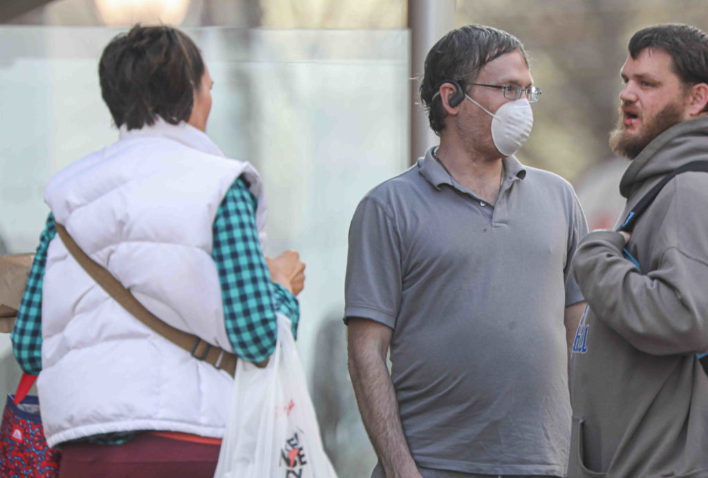 News 2020 – Mar 27 – Residents seen walking down Market Street with protective mask on their faces People on Market Street in Wilmington, Del. wearing protective masks on Friday, March 27, 2020. (Saquan Stimpson for WHYY)