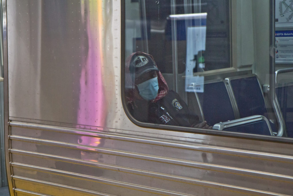 A SEPTA rider dons a surgical mask. (Kimberly Paynter/WHYY) A SEPTA rider dons a surgical mask. (Kimberly Paynter/WHYY)