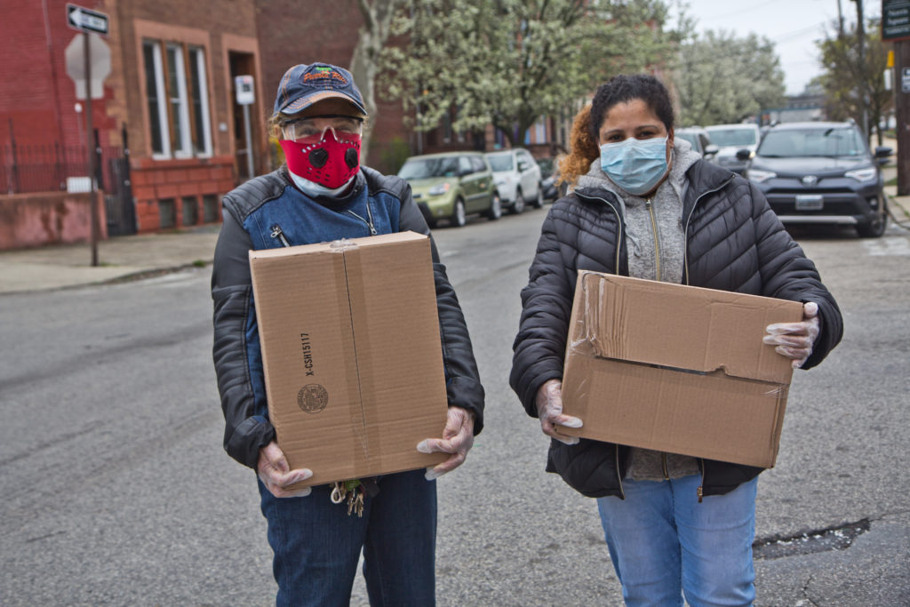 2020 3 30 k paynter free food pickup Noelia Ramírez and her daughter Carmen Arroyo, a factory worker, picked up boxes of free food during the coronavirus shutdowns that have students out of schools and workers unemployed. (Kimberly Paynter/WHYY)
