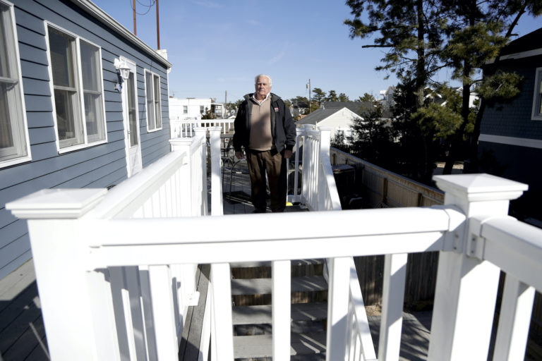 In a photo taken Friday, Jan. 11, 2019, Vince Farias poses for The Associated Press outside one of his vacation rental properties in Surf City, N.J. (Julio Cortez/AP Photo)