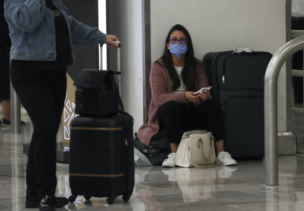 Mexico Virus Outbreak A woman wears protective masks as a precaution against the spread of the new coronavirus at the airport in Mexico City, Friday, Feb. 28, 2020. (Marco Ugarte/AP Photo)