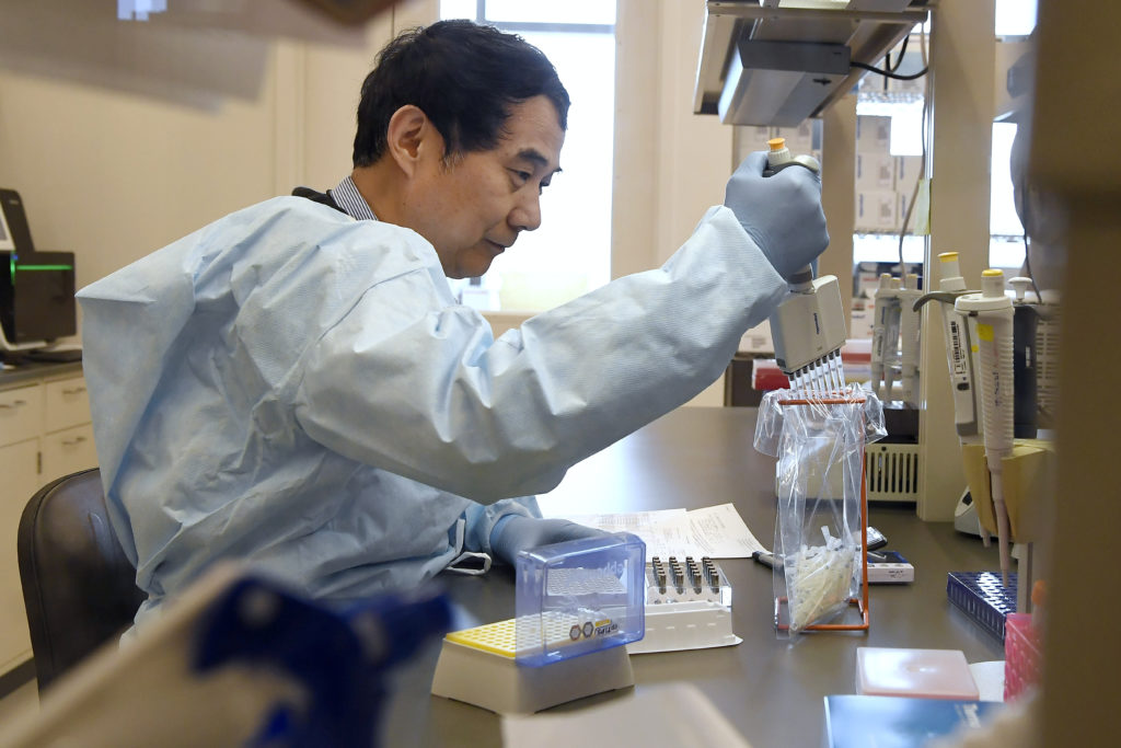 Virus Outbreak Surgeon General Microbiologist Xiugen Zhang runs a Polymerase Chain Reaction (PCR) test at the Connecticut State Public Health Laboratory, Monday, March 2, 2020, in Rocky Hill, Conn. (Jessica Hill/AP Photo)