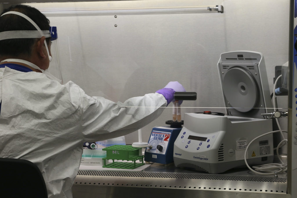 Virus Outbreak-Hawaii Hawaii state Department of Health microbiologist Mark Nagata demonstrates the process for testing a sample for coronavirus at the department's laboratory in Pearl City, Hawaii. (Audrey McAvoy/AP Photo)