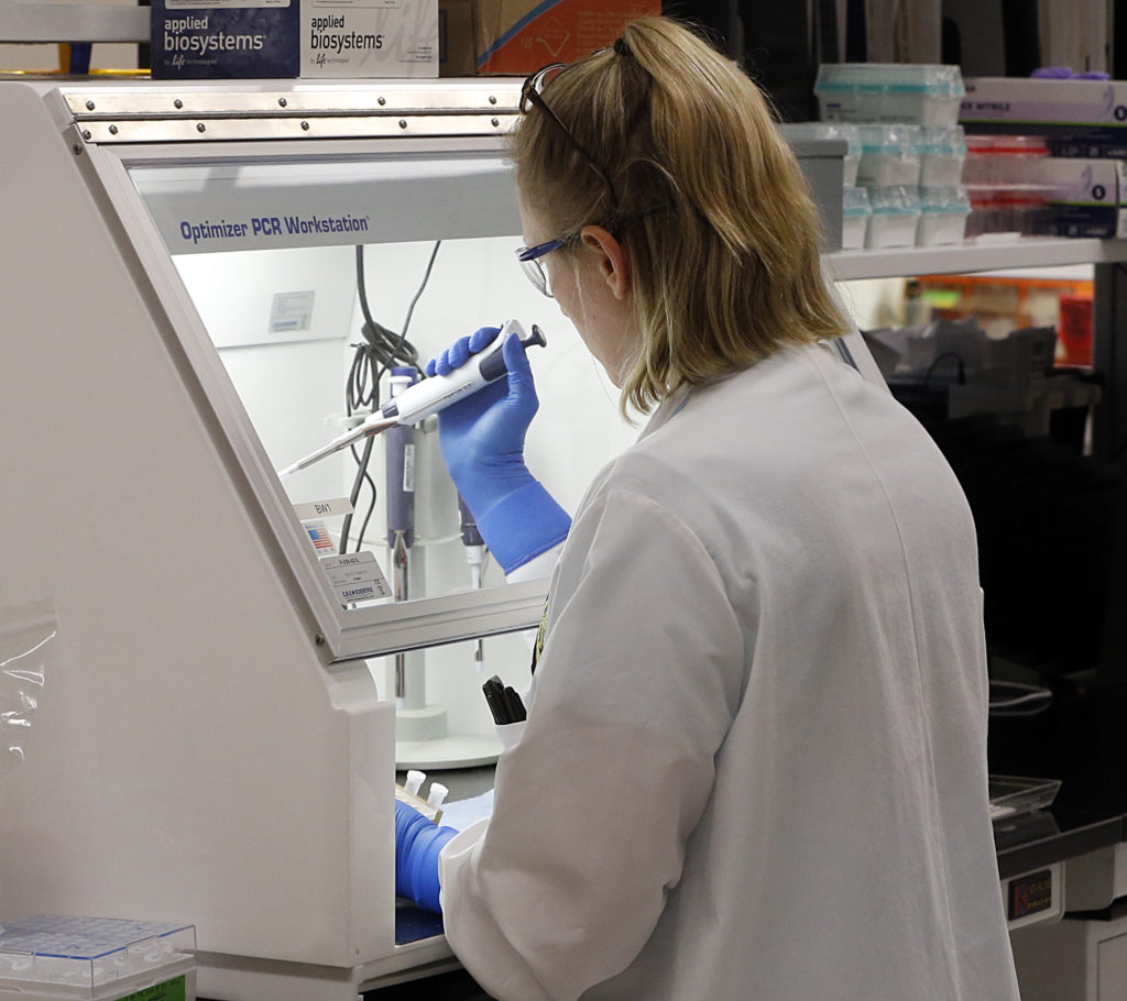Virus Outbreak Virginia An employee of the Department of General Services Division of Consolidated Laboratories' Virginia Public Health Labratory adds chemicals in the second step of testing a sample for the Coronavirus at the lab in Richmond, Va. on Wednesday, March 4, 2020. ( Joe Mahoney/Richmond Times-Dispatch via AP)