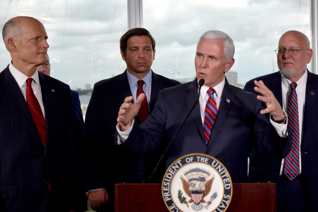 Virus Outbreak Pence Vice President Mike Pence, center, along with Florida Senator Rick Scott, far left, and Governor Ron DeSantis,left, and CDC Director Dr.Robert Redfield,right, speaks to the media in Fort Lauderdale, Fla. (Gaston De CardenasAP Photo)