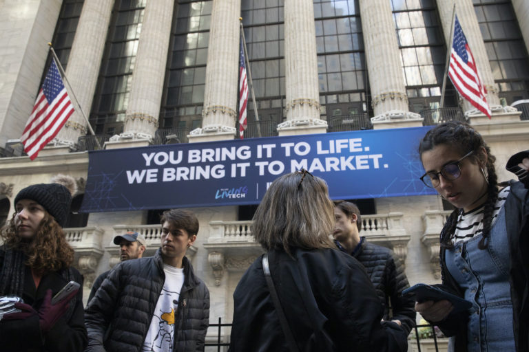 In this Monday, March 9, 2020 file photo, people stop to look at the New York Stock Exchange. Stocks are opening sharply lower on Wall Street Wednesday as fears of economic fallout from the coronavirus outbreak grip markets again.  (Mark Lennihan/AP Photo)