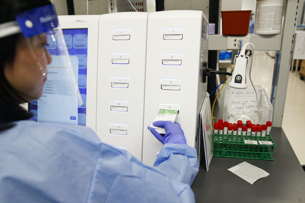 Virus Outbreak New York A laboratory technician prepares COVID-19 patient samples for semi-automatic testing at Northwell Health Labs, in Lake Success, N.Y. (John Minchillo/AP Photo)