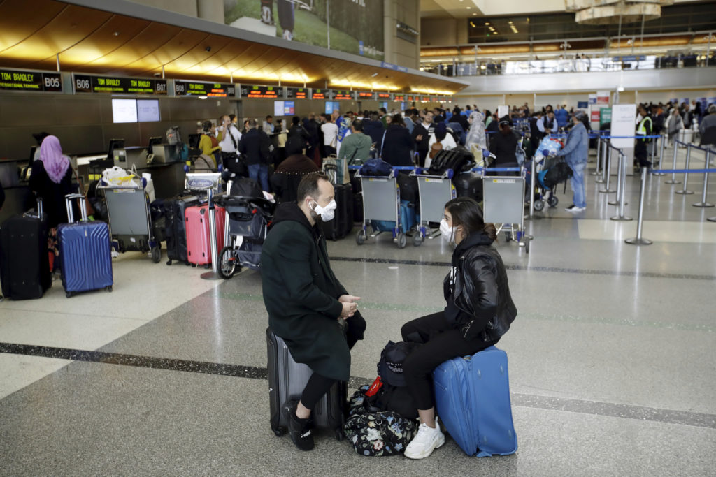 Joe Biden Travelers wait to check in their luggage at the Los Angeles International Airport Saturday, March 14, 2020, in Los Angeles. The coronavirus outbreak is hitting the airline industry hard. President Trump banned most Europeans from entering the United States for 30 days to try to slow down the spread of the virus. The new travel ban is likely to further roil the airline industry as bookings decline and people cancel reservations out of fear they might contract the virus.(AP Photo/Marcio Jose Sanchez)