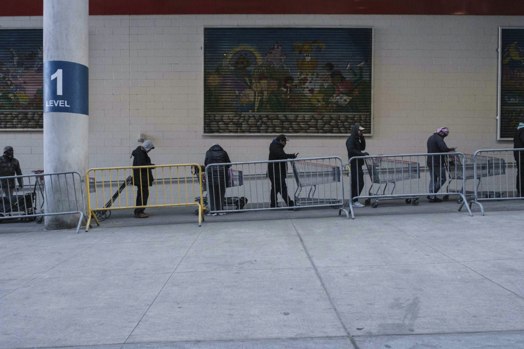 Virus Outbreak New York New Jersey joined with New York and Connecticut to close bars, restaurants and movie theaters starting Monday night. Here, customers wait in line at a store in New York. (Yuki Iwamura/AP Photo)