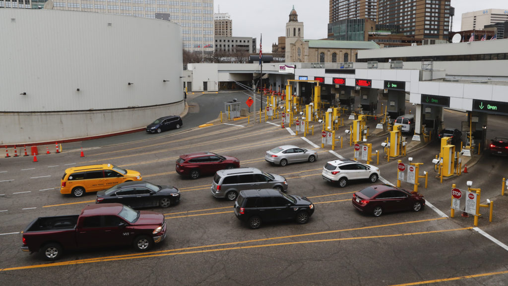 Vehicles enter the United States as a minivan drives to Canada in the Detroit-Windsor Tunnel in Detroit, Monday, March 16, 2020. Canadian Prime Minister Justin Trudeau says he is closing his country's borders to anyone not a citizen or a permanent resident or American amid the coronavirus pandemic. (AP Photo/Paul Sancya)