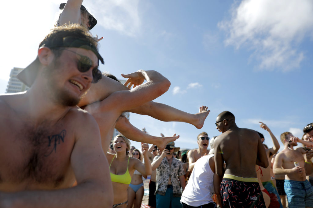 Virus Outbreak Florida Spring break revelers party on the beach, Tuesday, March 17, 2020, in Pompano Beach, Fla. (Julio Cortez/AP Photo)
