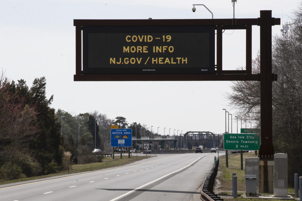 Virus Outbreak Fleeing Cities A notice is displayed above the lightly traveled Garden State Parkway in Ocean View, N.J., Wednesday, March 18, 2020. (AP Photo/Matt Rourke)