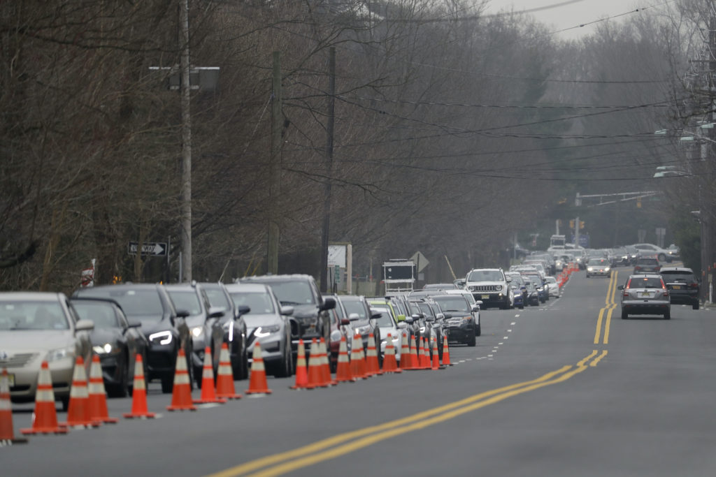 Virus Outbreak New Jersey A long line of cars waits to enter a drive-through COVID-19 coronavirus testing center in Paramus, N.J., Friday, March 20, 2020. (Seth Wenig/AP Photo)