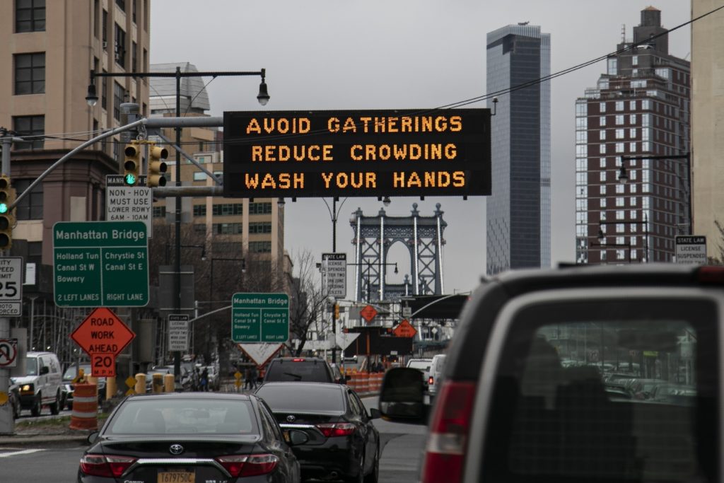 Virus Outbreak Misinformation Overload The Manhattan bridge is seen in the background of a flashing sign urging commuters to avoid gatherings, reduce crowding and to wash hands in the Brooklyn borough of New York. (Wong Maye-E/AP Photo, file)