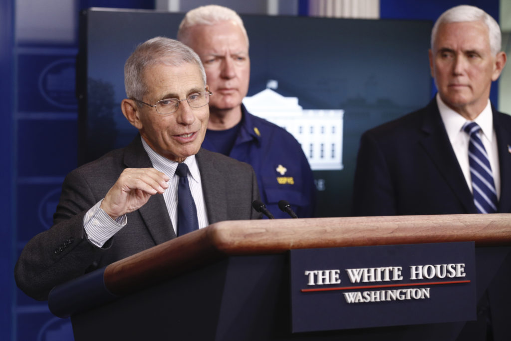 Donald Trump Director of the National Institute of Allergy and Infectious Diseases Dr. Anthony Fauci speaks during a coronavirus task force briefing at the White House, Saturday, March 21, 2020, in Washington. Adm. Brett Giroir, assistant secretary for health, center, and Vice President Mike Pence listen. (AP Photo/Patrick Semansky)