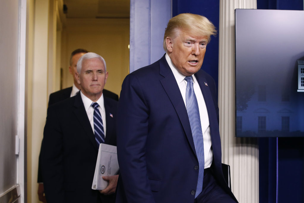 President Donald Trump and Vice President Mike Pence arrive to speak at a coronavirus task force briefing at the White House, Saturday, March 21, 2020, in Washington. (AP Photo/Patrick Semansky)