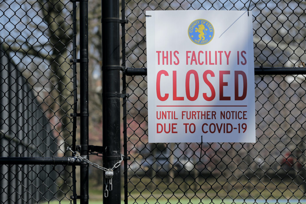 Virus Outbreak New Jersey A sign is displayed on locked tennis courts in Branch Brook Park in Newark, N.J., Thursday, March 26, 2020. (Seth Wenig/AP Photo)