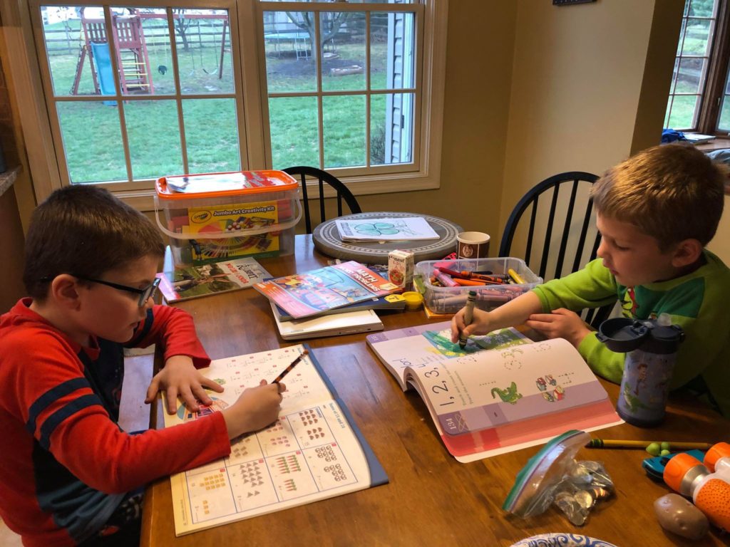 Andrew and Luke Tara Ryan-Schill's sons Andrew, left, and Luke, right, doing schoolwork at home. Andrew is an 8-year-old on the autism spectrum. (Courtesy of Tara Ryan-Schill)