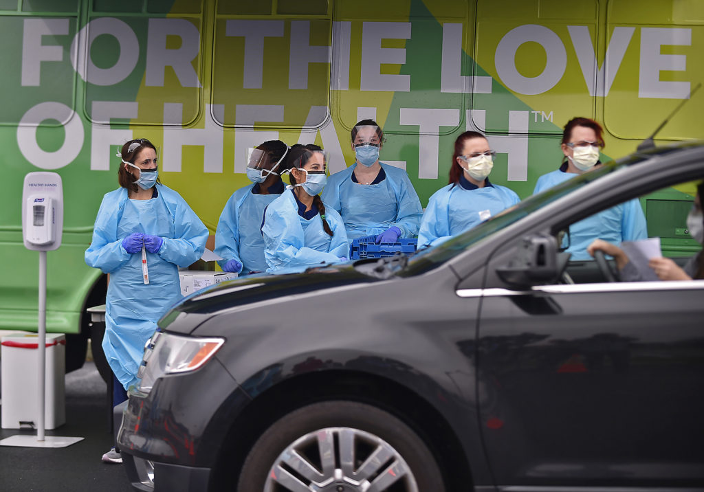 CoronavirusTesting03 Nurses with ChristianaCare wait for the next vehicle to arrive to test people for the coronavirus on Friday, March 13, 2020, at the Riverfront complex in downtown Wilmington, Del. (Butch Comegys for WHYY)