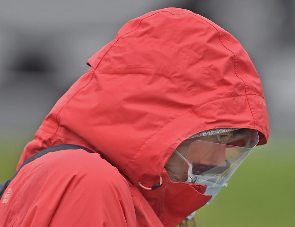 A woman walks across Beech Street after being tested for the coronavirus at the Riverfront complex in downtown Wilmington, Delaware on Friday, March 13, 2020. Christiana Care, Delaware's largest health system, provided the free tests. (Butch Comegys / For WHYY)