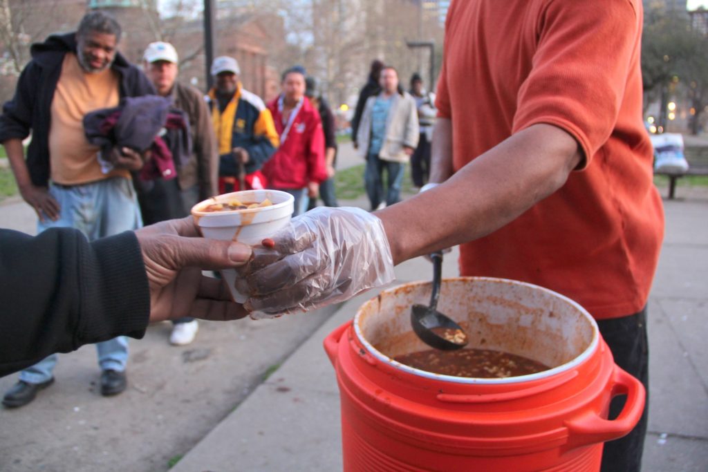 homeless food People line up for a meal in Pennypacker Park across from the Family Court building on Vine Street. (Emma Lee for WHYY)