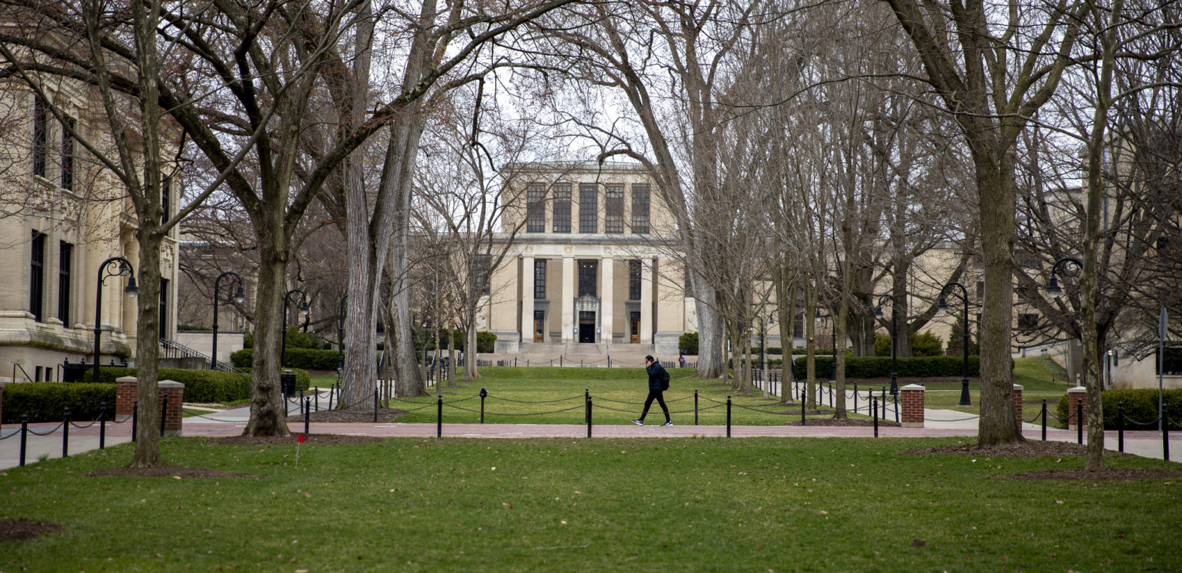 A student walks alone at Penn State’s University Park campus, where coronavirus has suspended in-person classes. (Min Xian / WPSU)