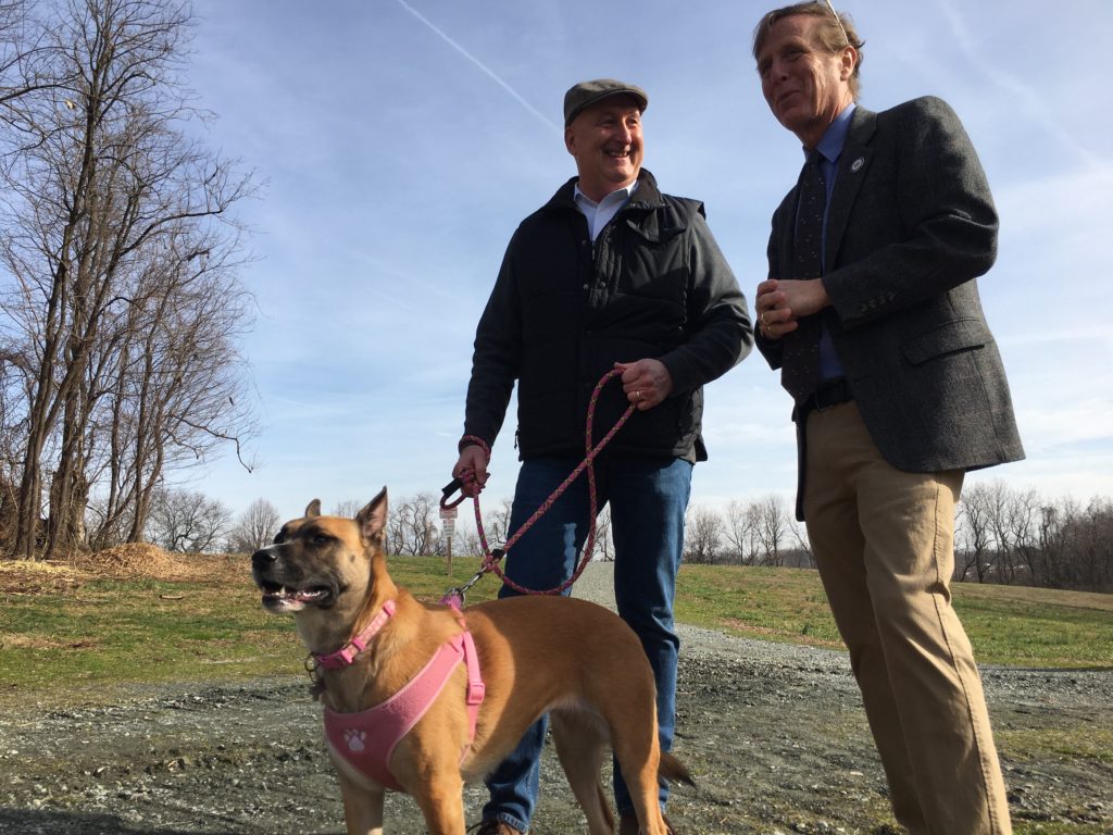 IMG_7301 State Sen. Jack Walsh (left) holds his dog Maisey as he talks with State Rep. Mike Ramone at the Carousel Park Bark Park Wednesday morning. Both lawmakers sponsored a bill extending protections for dogs being kept outside. (Mark Eichmann/WHYY)