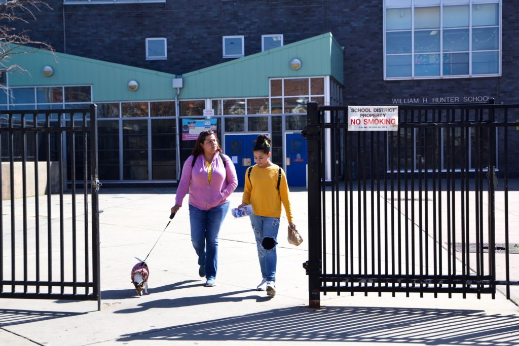 Image from iOS (14) Xiomara Diaz and her daughter Genesis Diaz leave William Hunter School in Kensington with free meals because of the coronavirus shutdown. (Kimberly Paynter/WHYY)