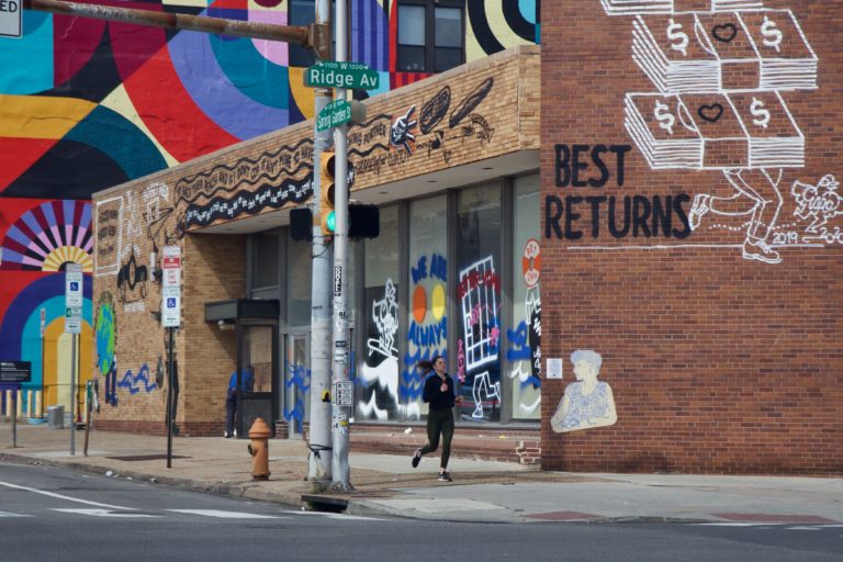 A runner at Ridge Avenue and Spring Garden Street on Tuesday, March 24, 2020. (Kimberly Paynter/WHYY)
