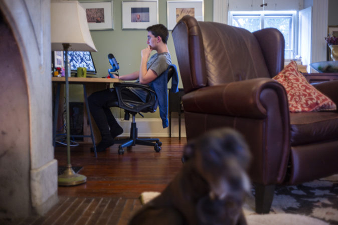 Riley Prell, a high-school freshman at Science Leadership Academy, is isolated at home with his two parents and his college-aged sister. (Jessica Kourkounis for Keystone Crossroads)