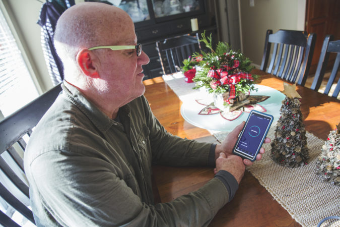 Tom Bracken, a volunteer at the cooperative, tests the DSL internet speeds at home. (Min Xian/Keystone Crossroads)