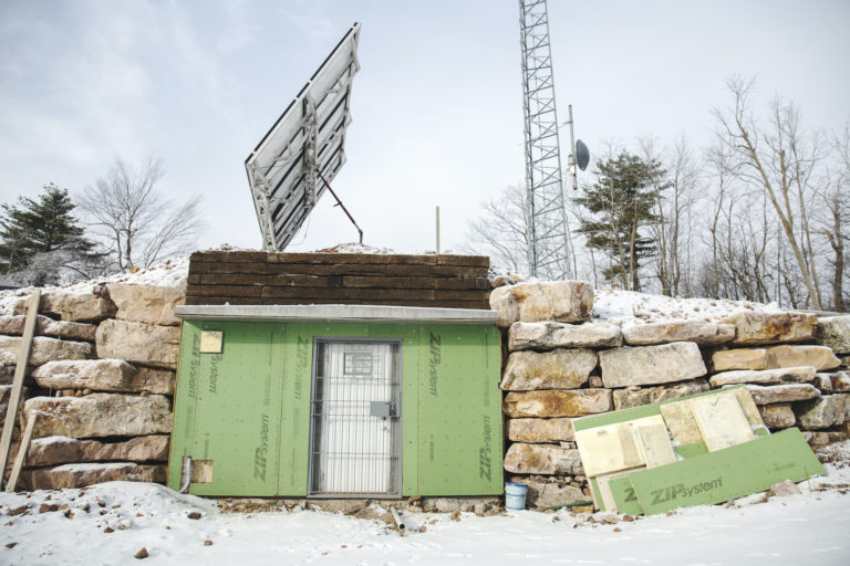 The set up on Stone Mountain consists of a radio tower, solar panels and an equipment room and is key to how the Rural Broadband Cooperative is delivering broadband internet to its users. (Min Xian/Keystone Crossroads)