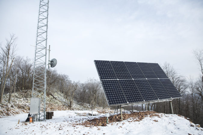 The cooperative’s volunteers bring their trades and skills together to construct the radio tower and solar panels on their own. (Min Xian/Keystone Crossroads)