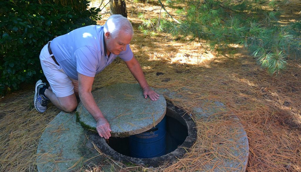 Water-well-guy-one-e1583096339542-1920×1099 Jerry Solomon, of West Lampeter Township, rolls the stone slab that covers his private well water pump at the back of his home on Dec. 9, 2019. (Brett Sholtis/Transforming Health)