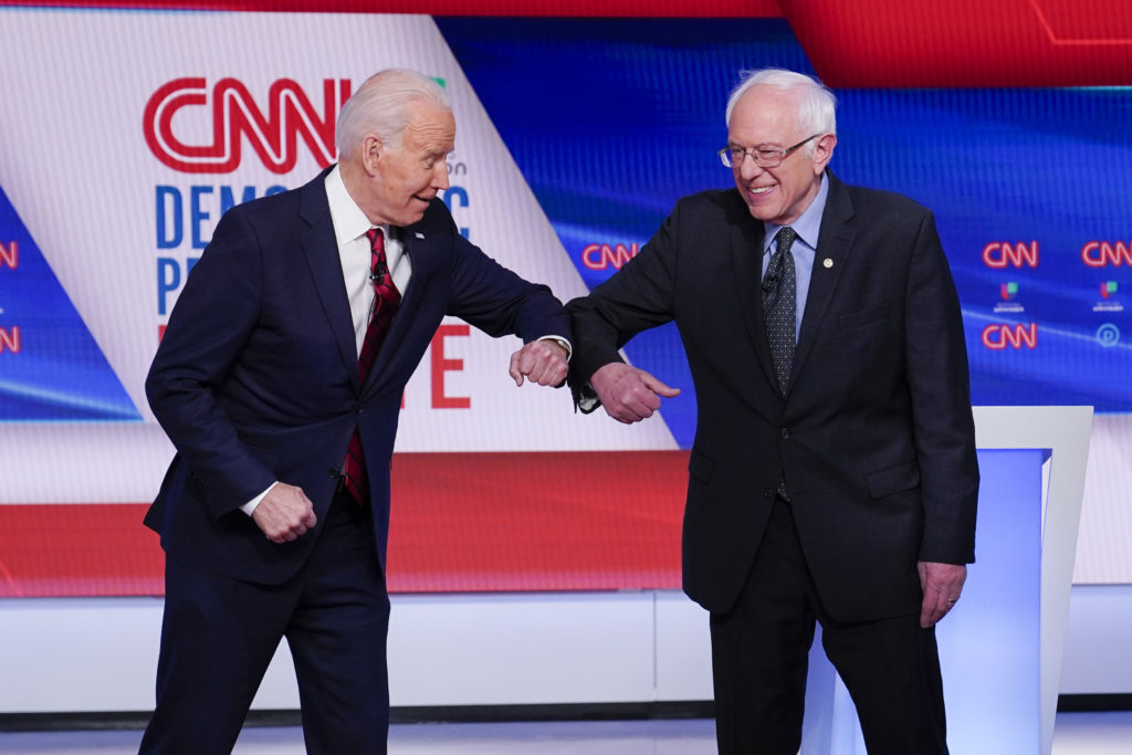 Joe Biden, Bernie Sanders Former Vice President Joe Biden, left, and Sen. Bernie Sanders, I-Vt., right, greet one another before they participate in a Democratic presidential primary debate at CNN Studios in Washington, Sunday, March 15, 2020. (AP Photo/Evan Vucci)
