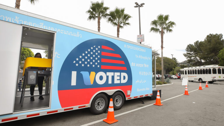 A voter prepares her ballot during early voting for the California presidential primary election at a new LA County 
