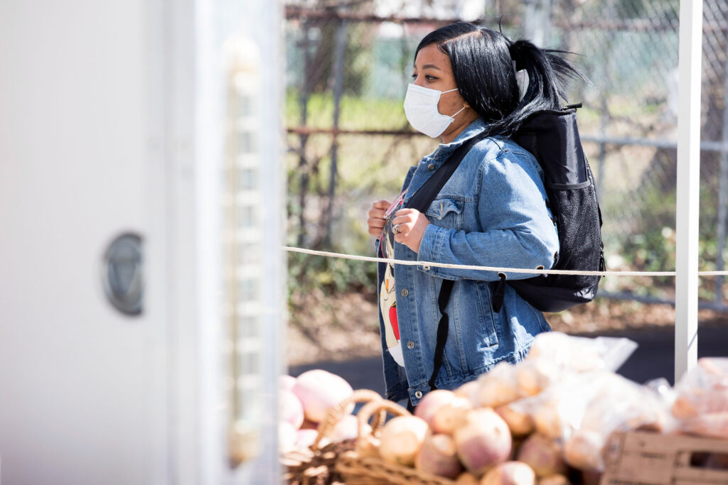 2020 04 11-r wisniewski-njeri harris-COVID farmers markets-philadelphia clark park Njeri Harris shops for produce at the Landisdale Farm stand at Clark Park on April 11, 2020. Harris says that the lines enforcing social distancing are