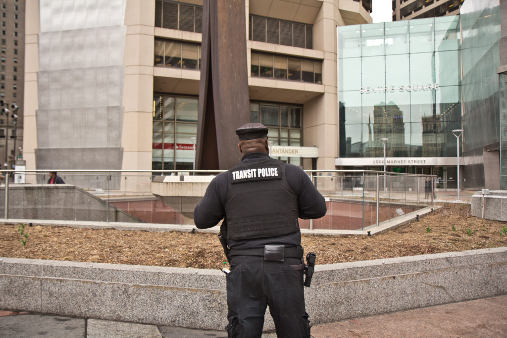 2020 3 17 k paynter public transit and streets-8 Transit police stand outside the Clothes Pin in Center City. (Kimberly Paynter/WHYY)