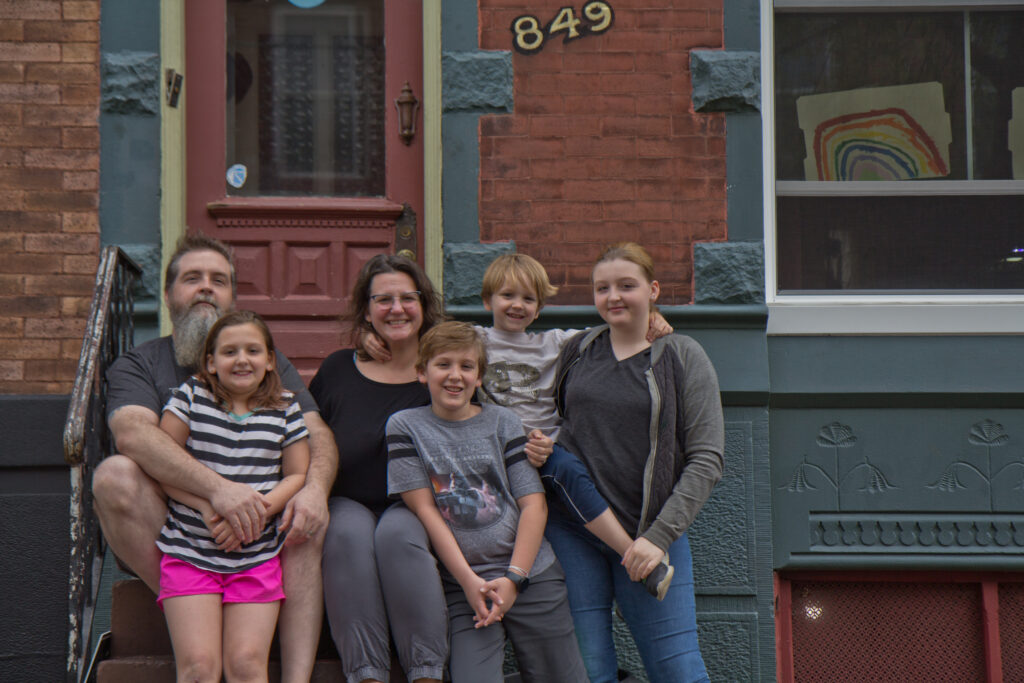 2020 4 9 k paynter fairmount family portrait Wayne and Andrea Clark with their children Molly, 9, Caleb, 11, Roisin, 13, and Cianan, 6, on the steps of their home in Philadelphia. (Kimberly Paynter/WHYY)