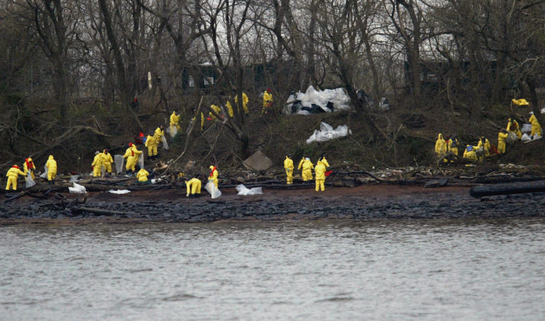 Work crews clean oil off the banks of the Delaware River in National Park, N.J., Monday, Dec. 6, 2004. The Athos I spilled as much as 470,000 gallons of thick crude oil into the Delaware River, killing wildlife and spreading along 70 miles of the waterway. (Joseph Kaczmarek/AP Photo)