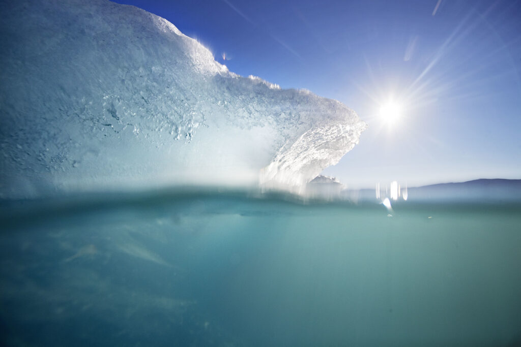 An icebergs floats in the Nuup Kangerlua Fjord in southwestern Greenland. Greenland's glaciers have been melting and retreating at an accelerated pace in recent years due to warmer temperatures. (AP Photo/David Goldman)