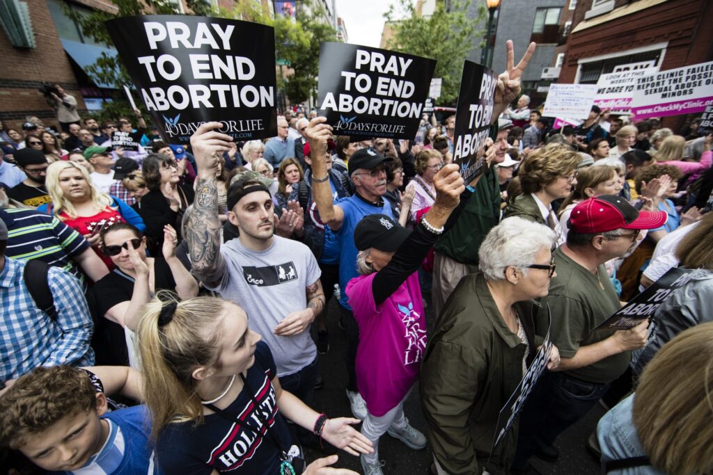 AP_19130596311925-1920×1280 Anti-abortion protesters rally near a Planned Parenthood clinic in Philadelphia, Friday, May 10, 2019. The demonstration was spurred by the actions of a Democratic state lawmaker who recorded himself berating an anti-abortion demonstrator at length outside the clinic. (AP Photo/Matt Rourke)