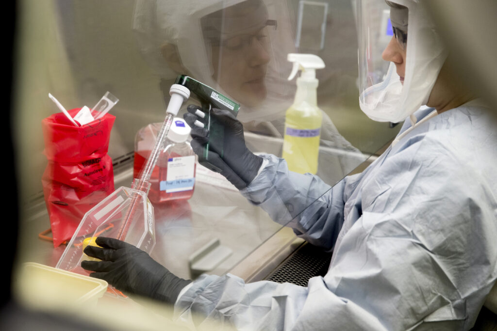 Laboratory Scientist Andrea Luquette cultures coronavirus to prepare for testing at U.S. Army Medical Research and Development Command at Fort Detrick in Frederick, Md., Thursday, March 19, 2020. (AP Photo/Andrew Harnik)