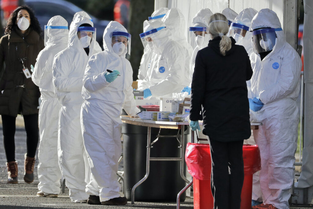 Virus Outbreak New Jersey Staff in protective equipment prepare to test people at a drive-thru COVID-19 testing site at the PNC Bank Arts Center in Holmdel, N.J.