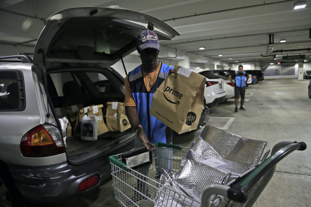 Samuel Diaz Samuel Diaz, a delivery worker for Amazon Prime, loads his vehicle with groceries from Whole Foods, Tuesday, March 31, 2020, in Miami, during the coronavirus pandemic. (Lynne Sladky/AP Photo)