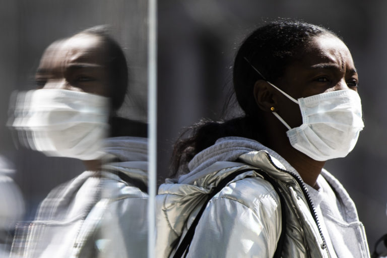 A person wearing protective masks due to coronavirus concerns walks in Philadelphia, Thursday, April 2, 2020. (AP Photo/Matt Rourke)