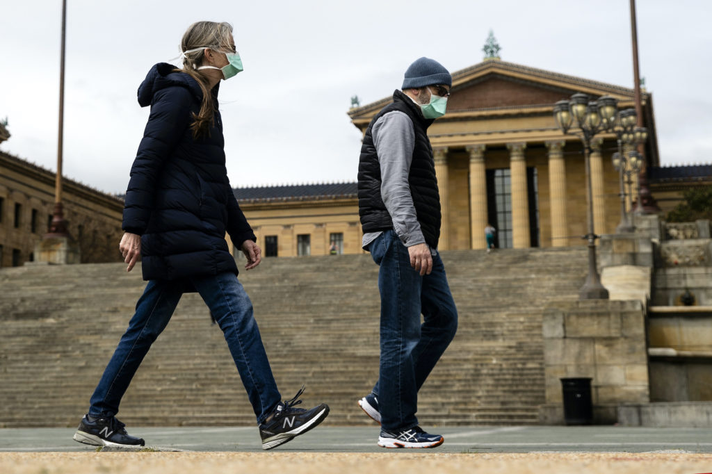 Virus Outbreak Pennsylvania Daily Life A couple in protective masks walk past the Philadelphia Museum of Art in Philadelphia, Friday, April 3, 2020.