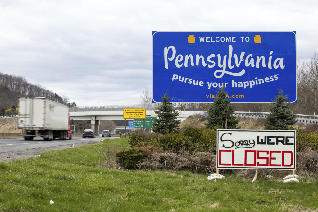 Virus Outbreak Pennsylvania A sign reading “Sorry We’re Closed” is placed at the Pennsylvania welcome sign on the westbound lanes of Interstate 80 in Delaware Water Gap, Pa. on Saturday, April 4, 2020. (Christopher Dolan/The Times-Tribune via AP)