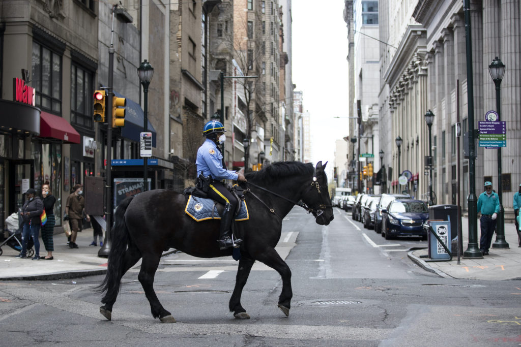 Virus Outbreak Pennsylvania Daily Life A mounted officer patrols while wearing a face mask to protect against the spread of new coronavirus, in Philadelphia, Wednesday, April 8, 2020. (AP Photo/Matt Rourke)